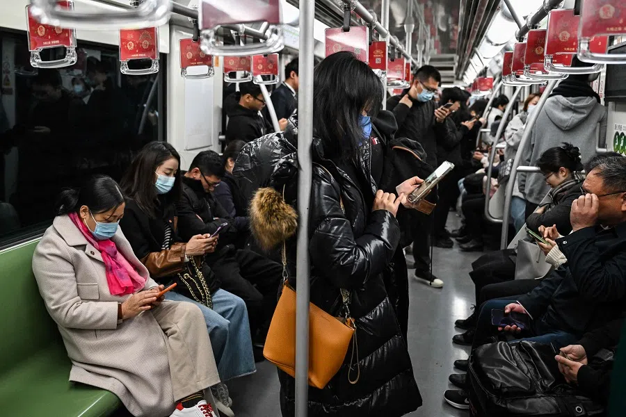 People travel on a subway in Shanghai on 5 December 2023. (Hector Retamal/AFP)