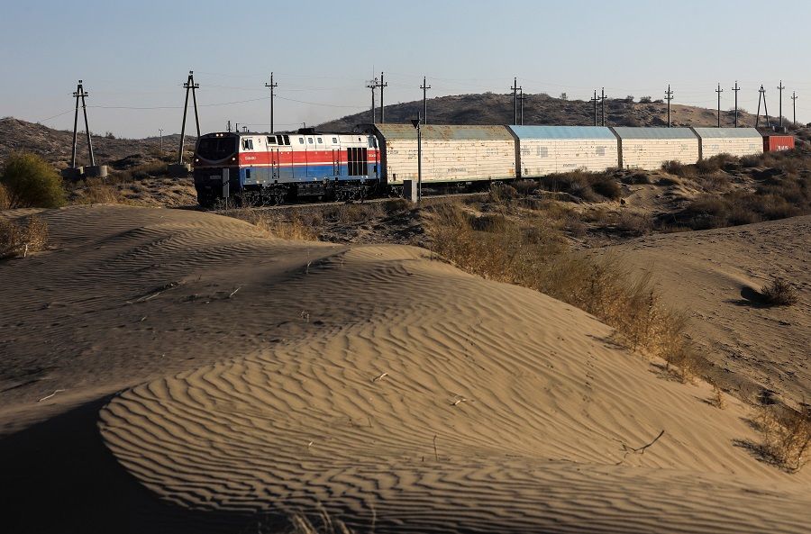 A train drives across a deserted area close to the Altynkol railway station near the Khorgos border crossing point on the border with China in Kazakhstan, 26 October 2021. (Pavel Mikheyev/Reuters)