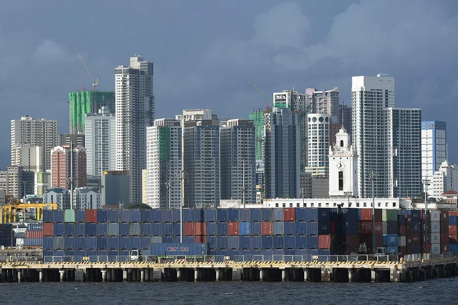 Container vans are seen stacked up next to buildings near the Port of Manila, Philippines, on 9 August 2024. (Ted Aljibe/AFP)