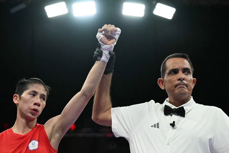 Taiwan’s Lin Yu-ting is declared victorious at the end of her fight against Uzbekistan’s Sitora Turdibekova in the women’s 57kg preliminaries round of 16 boxing match during the Paris 2024 Olympic Games at the North Paris Arena, in Villepinte on 2 August 2024.  (Mohd Rasfan/AFP)