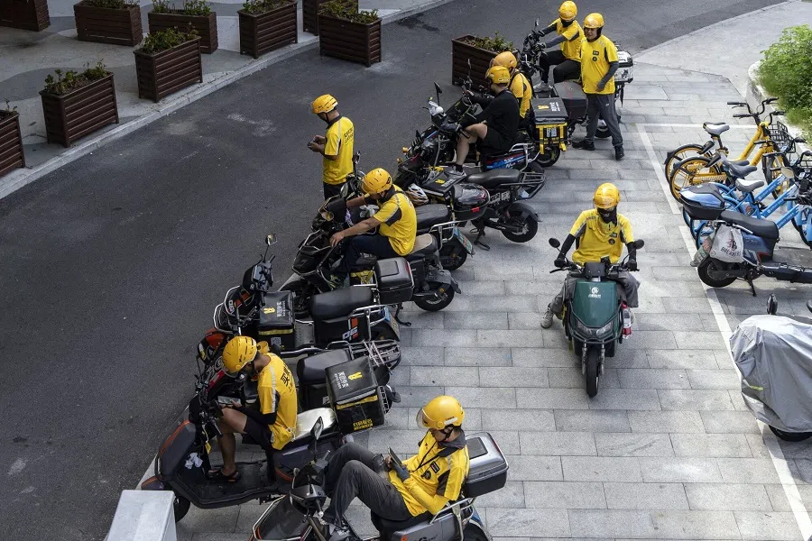 Food delivery couriers for Meituan in Shanghai, China, on 25 August 2024. (Qilai Shen/Bloomberg)