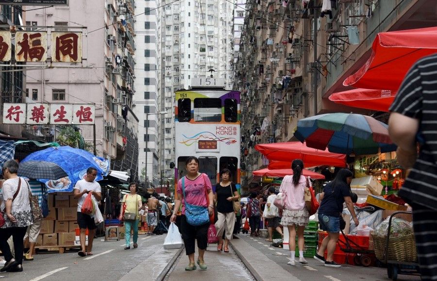 A tram tries to pass through the market in North Point - the only section of a tram route in Hong Kong that runs through a wet market. (SPH Media)