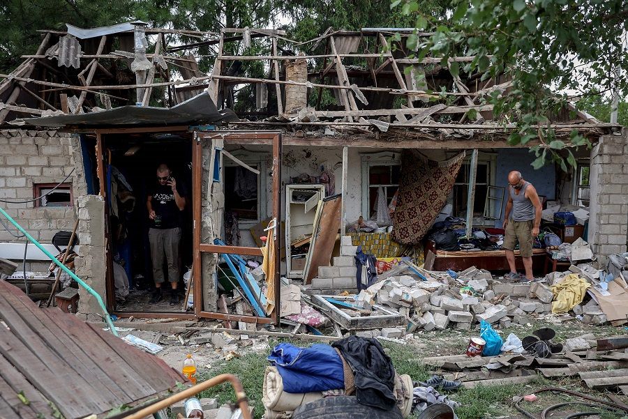 Local residents collect belongings from their destroyed house after a night missile strike in the town of Kramatorsk, in Donetsk region, on 16 August 2022, amid the Russian military invasion of Ukraine. (Anatolii Stepanov/AFP)