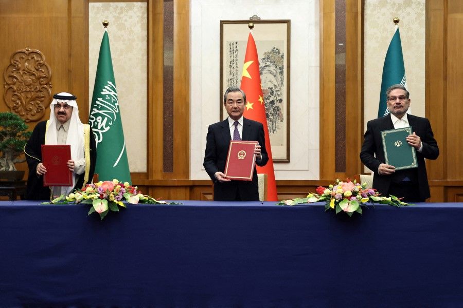 Wang Yi, a member of the Political Bureau of the Communist Party of China Central Committee and director of the Office of the Central Foreign Affairs Commission attends a meeting with Secretary of Iran's Supreme National Security Council Ali Shamkhani and Minister of State and national security adviser of Saudi Arabia Musaad bin Mohammed Al Aiban in Beijing, China, 10 March 2023. (China Daily via Reuters)