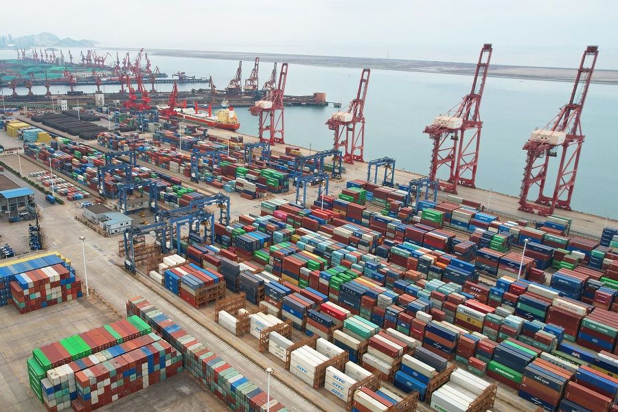 This aerial photo shows cargo containers stacked at a port in Lianyungang, Jiangsu province, China, on 9 May 2022. (AFP)