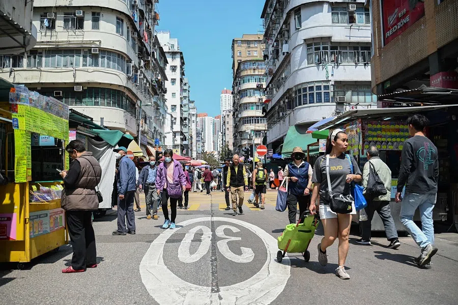 Pedestrians walk along a street in Hong Kong, China, on 19 March 2025. (Peter Parks/AFP)