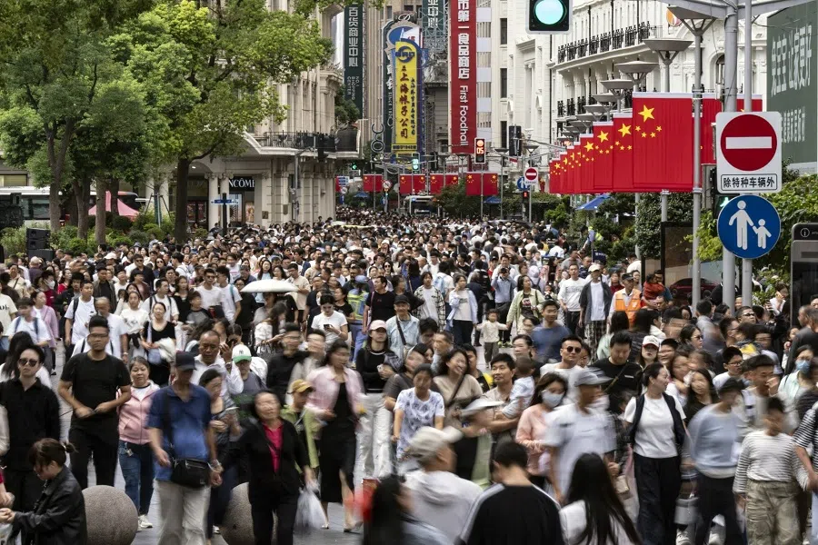 Shoppers on Nanjing East Road in Shanghai, China, 2 October 2024. (Qilai Shen/Bloomberg)