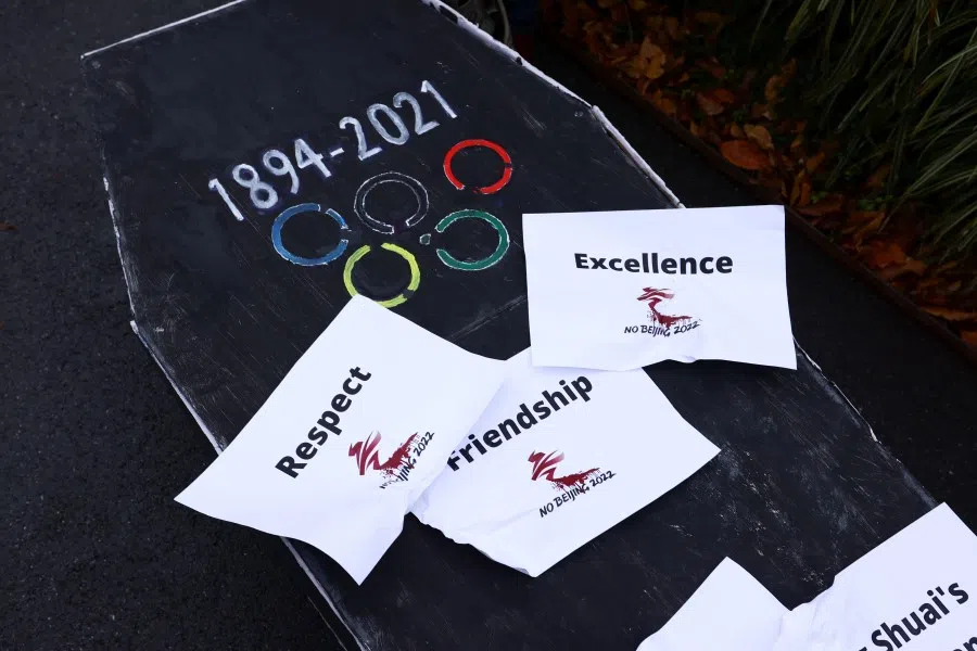 A coffin is displayed as protesters take part in a mock funeral outside the International Olympic Committee (IOC) headquarters as part of the No Beijing 2022 campaign, a coalition of over 180 rights groups that are calling for a boycott of Beijing 2022, in Lausanne, Switzerland, 26 November 2021. (Denis Balibouse/Reuters)
