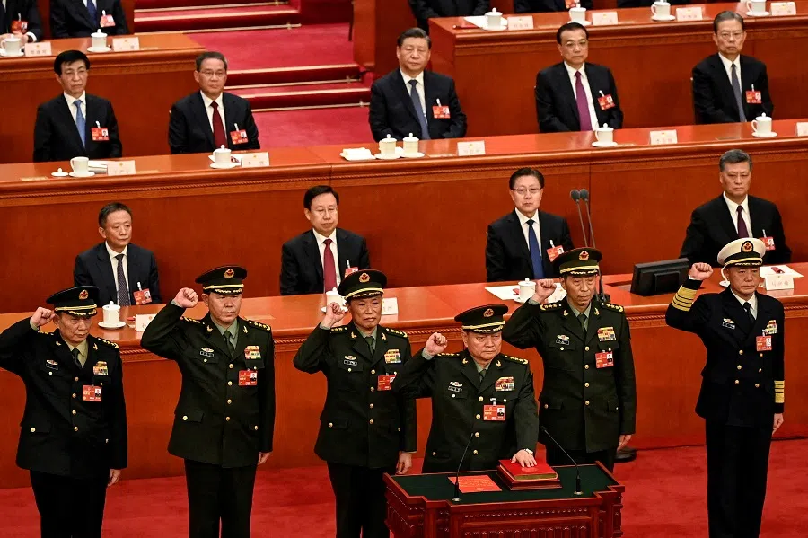 Zhang Youxia (front), newly-elected vice-chairman of the Central Military Commission (CMC) of the People's Republic of China, swears an oath with members of the CMC (left to right) Zhang Shengmin, Liu Zhenli, He Weidong, Li Shangfu, and Miao Hua, after they were elected during the fourth plenary session of the National People's Congress (NPC) at the Great Hall of the People in Beijing, China, on 11 March 2023. (Greg Baker/Pool via Reuters)