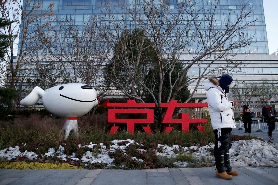 A man stands outside JD.com's headquarters, amid the Singles' Day shopping festival, during an organised tour in Beijing, China, 9 November 2021. (Tingshu Wang/Reuters)