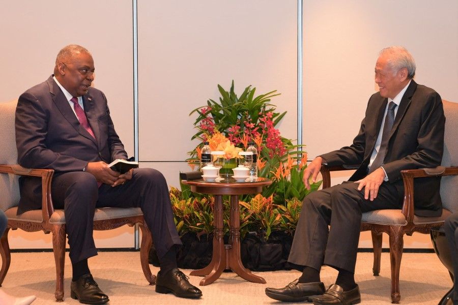 This handout from MINDEF Singapore taken and released on 10 June 2022 shows US Defense Secretary Lloyd Austin (left) talking to Singapore's Defence Minister Ng Eng Hen on the sidelines of the Shangri-La Dialogue summit in Singapore. (Handout/MINDEF Singapore/AFP)