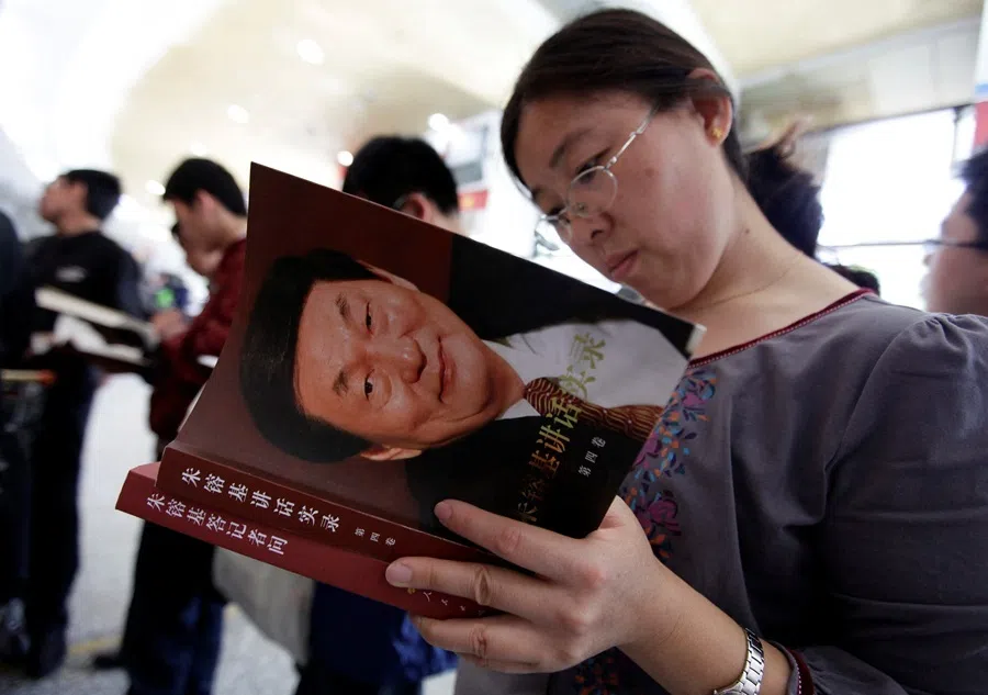 A woman browses a newly published book of China's former premier Zhu Rongji at a bookstore in Beijing on 19 September 2011.