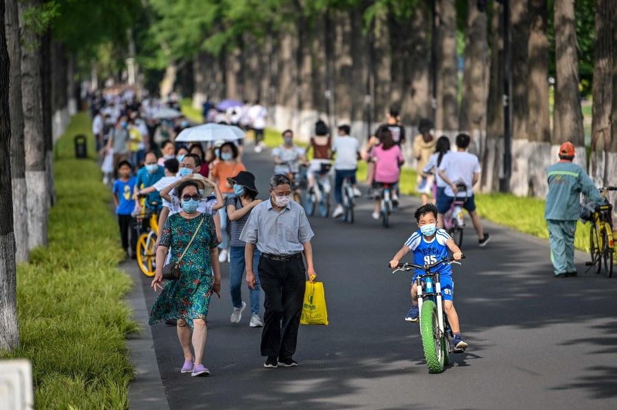People walk in Moshan Scenic Area Qinshui Platform in the East Lake in Wuhan, 17 May 2020. (Hector Retamal/AFP)
