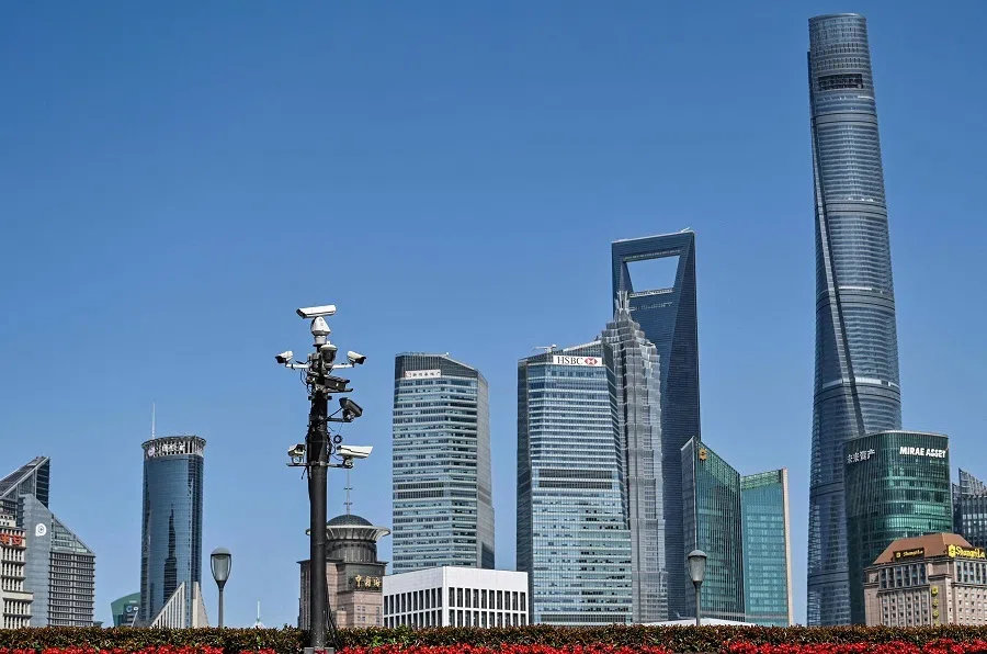 A tower of security cameras (centre, left) stands on The Bund past the Lujiazui financial district in the background, in Shanghai, China, on 23 May 2023. (Hector Retamal/AFP)