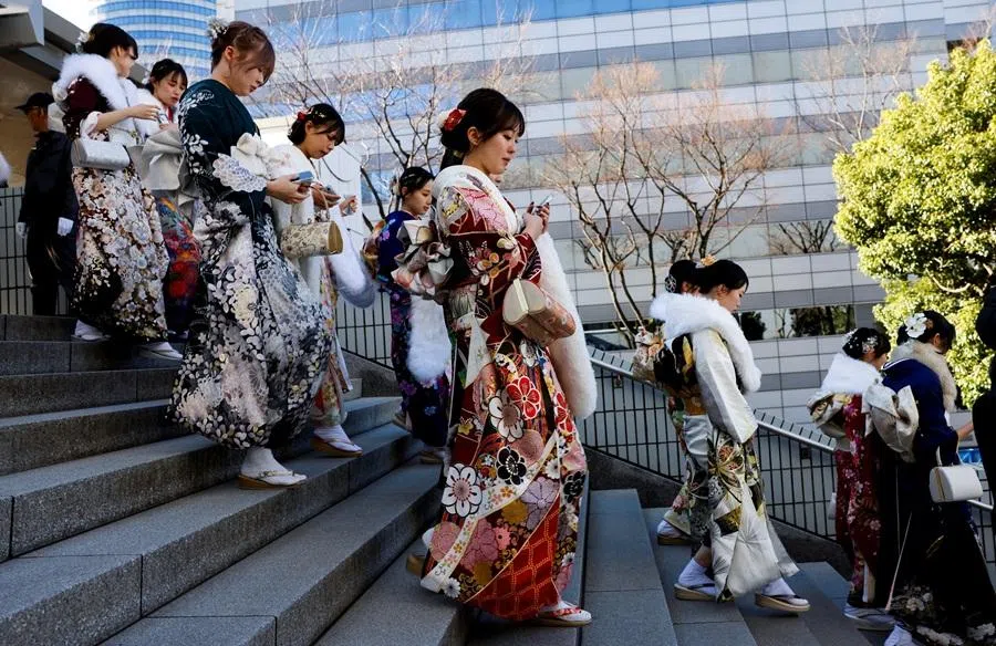 Kimono-clad young women walk on their way to a venue during their Coming of Age Day celebration ceremony in Yokohama, Japan, on 12 January 2026. (Manami Yamada/Reuters)