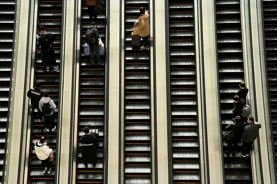 Passengers arrive at Beijing West railway station in Beijing, China, on 27 January 2022. (Noel Celis/AFP)