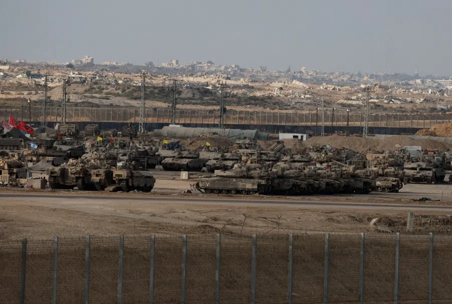 Israeli military vehicles are parked near the Israel-Gaza border, as seen from Israel, on 18 September 2025. (Ammar Awad/Reuters)