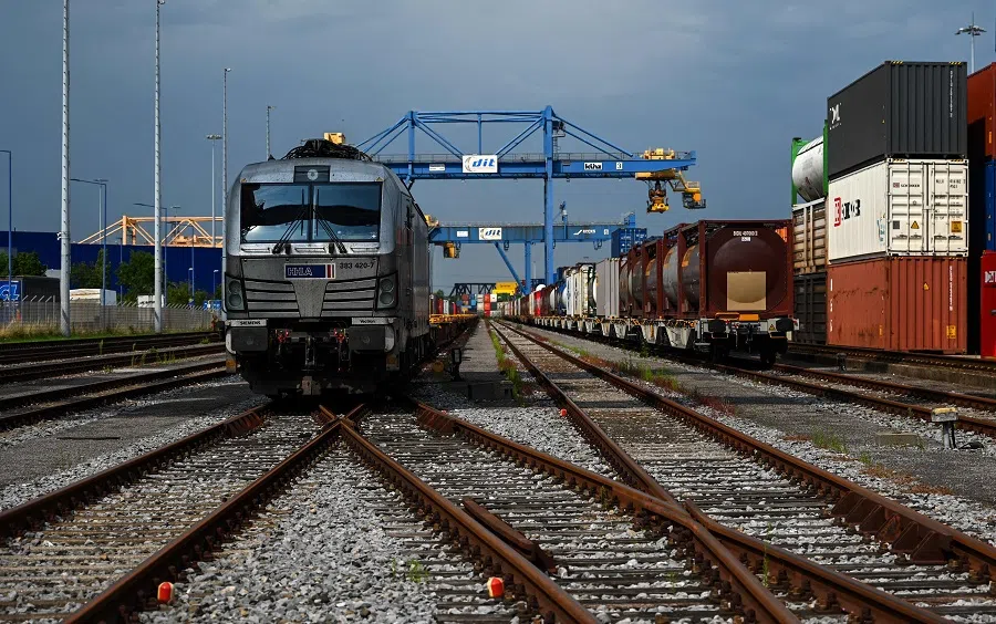 Containers are loaded from the railway at the seaport terminal DIT Duisburg Intermodal Terminal at the Duisburg harbour, Germany, on 13 July 2023. With the expansion of rail-bound freight traffic along the "new Silk Road", the port continues to expand its role as a hub or end point of the Silk Road, which connects China and numerous other Asian countries with the Port of Duisburg. (Ina Fassbender/AFP)