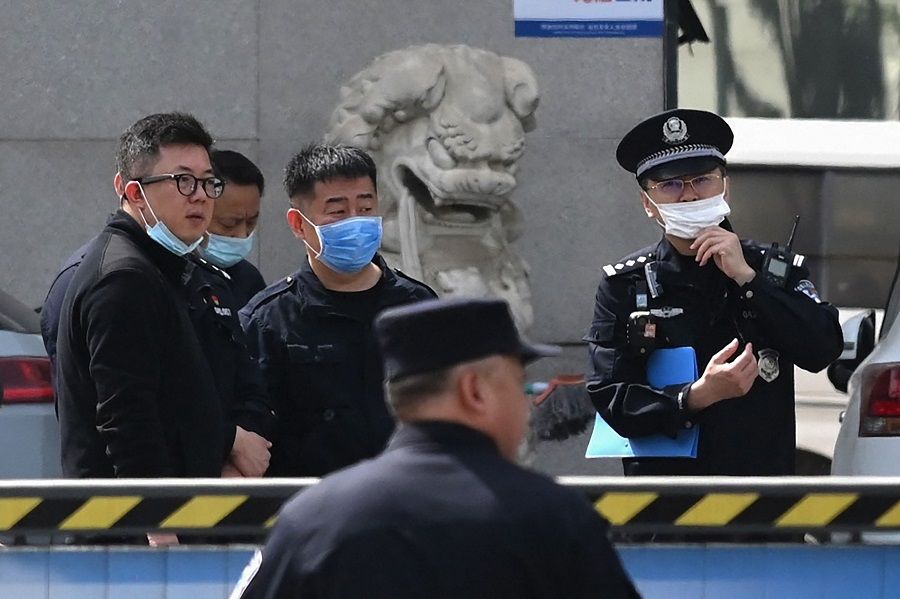 Police officers are seen at the Changfeng Hospital in Beijing on 19 April 2023, after a fire broke out a day earlier. (Greg Baker/AFP)