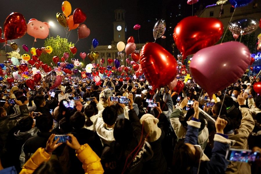 People release balloons as they gather to celebrate New Year's Eve, amid the coronavirus disease (Covid-19) outbreak, in Wuhan, Hubei province, China, 1 January 2023. (Tingshu Wang/Reuters)