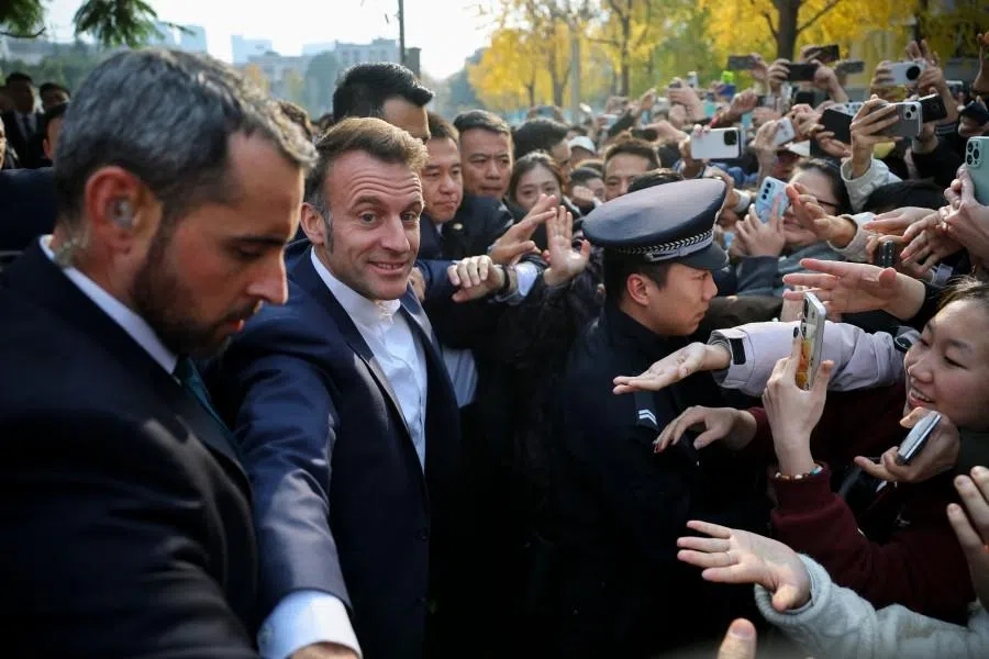 French President Emmanuel Macron (second from left) greets students during a visit to Sichuan University for a meeting with students in Chengdu, in southwestern China’s Sichuan province on 5 December 2025. (Sarah Meyssonnier/AFP)