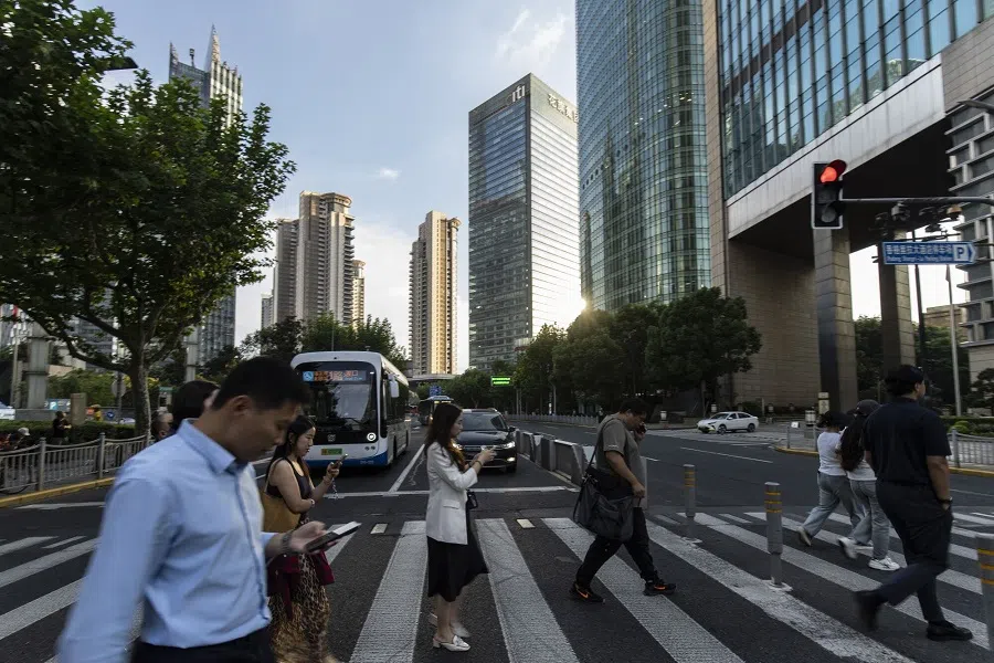 Pedestrians cross a road in front of the Citigroup Tower, centre, in Shanghai, China, on 27 September 2024. (Qilai Shen/Bloomberg)