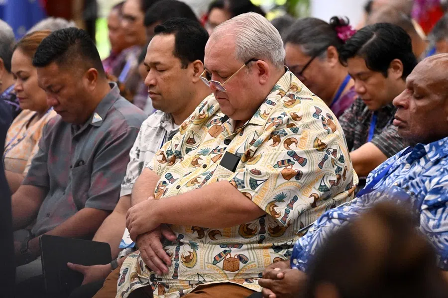 Papua New Guinea's Foreign Minister Justin Tkatchenko (centre) prays at the start of the Pacific Islands Forum Leaders plenary meeting in Koror on 2 September 2026.