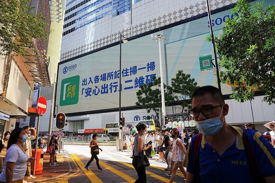 A QR code for LeaveHomeSafe, a contact tracing app for Covid-19, is seen on an electronic display outside a shopping mall, in Hong Kong, China, 13 July 2022. (Lam Yik/Reuters)