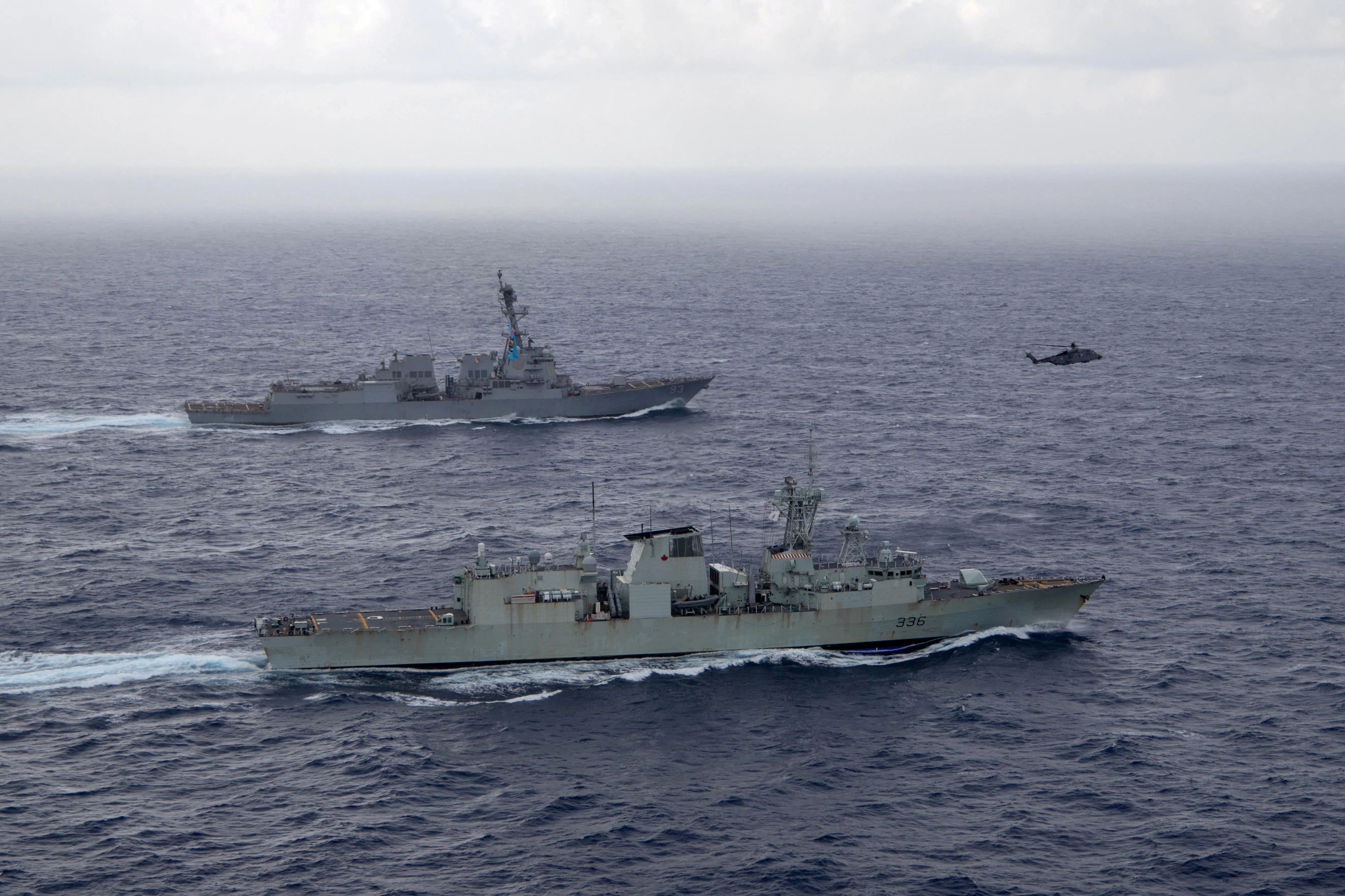 US Navy guided-missile destroyer USS Chung-Hoon sails alongside the Royal Canadian Navy frigate HMCS Montreal during Surface Action Group operations as a part of exercise “Noble Wolverine” in the South China Sea, on 30 May 2023. (US Navy/Naval Air Crewman (Helicopter) 1st Class Dalton Cooper/Handout via Reuters)