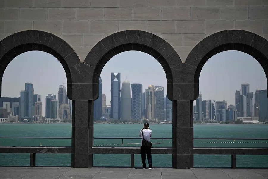 A visitor to the Museum of Islamic Art takes pictures of the skyline of high-rise buildings in Doha on 9 July 2026.