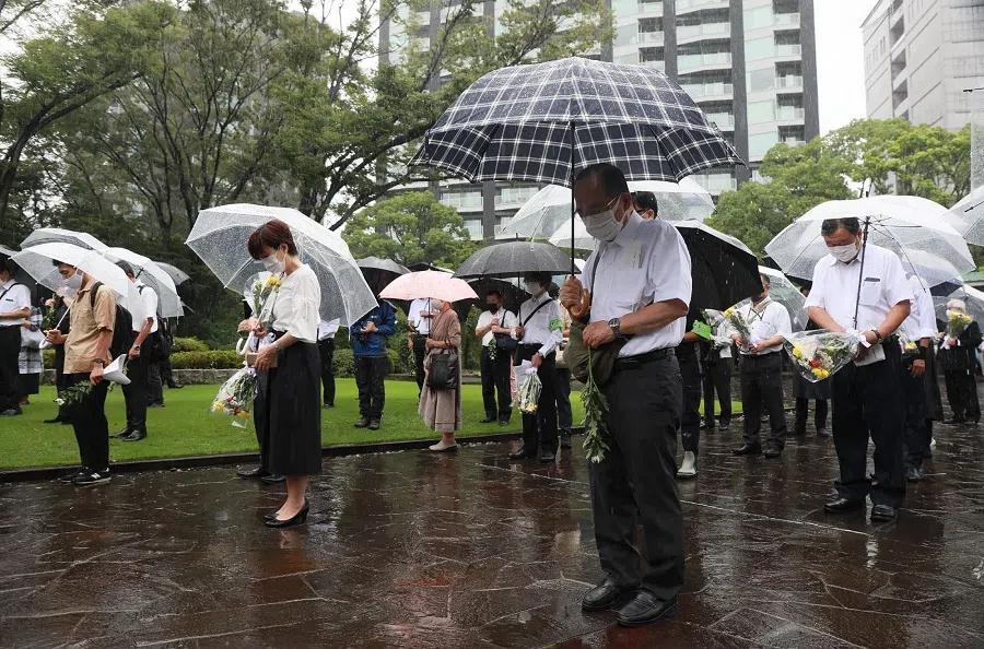 People offer a silent prayer at the Chidorigafuchi National Cemetery, a cemetery and memorial for unidentified war dead of World War II, in Tokyo on 15 August 2021, the 76th anniversary of the end of World War II. (STR/Jiji Press/AFP)