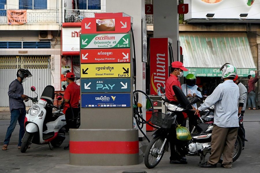 Motorists refill their vehicles with petrol at a gas station in Phnom Penh, Cambodia, on 3 March 2022. (Tang Chhin Sothy/AFP)
