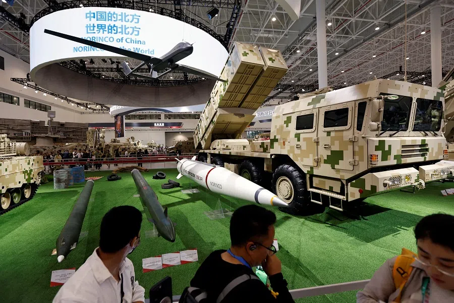 Visitors stand near weapon displays at the Norinco booth during the China International Aviation and Aerospace Exhibition, or Airshow China, in Zhuhai, Guangdong province, China, 14 November 2024. (Tingshu Wang/Reuters)