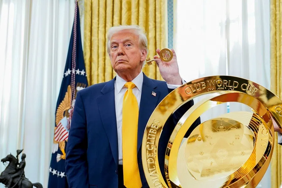 US President Donald Trump with the FIFA Club World Cup trophy during an executive order signing in the Oval Office of the White House in Washington, DC, US, on 7 March 2025.