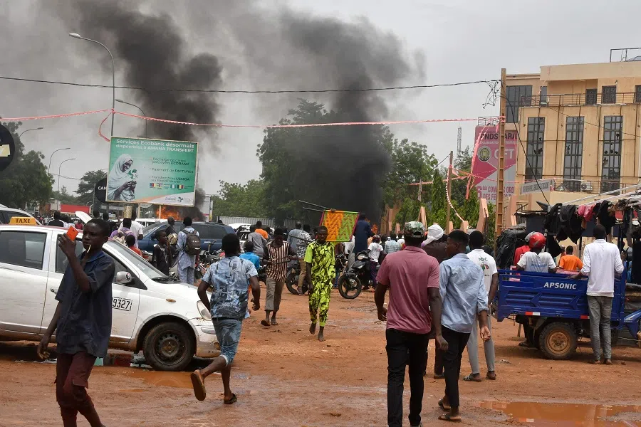A general view of billowing smoke as supporters of the Nigerien defence and security forces attack the headquarters of the Nigerien Party for Democracy and Socialism (PNDS), the party of overthrown President Mohamed Bazoum, in Niamey on 27 July 2023. (AFP)