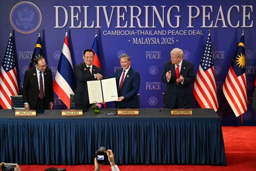 Malaysia’s Prime Minister Anwar Ibrahim (left) and US President Donald Trump (right) watch as Thailand’s Prime Minister Anutin Charnvirakul (second left) and Cambodia’s Prime Minister Hun Manet (second from right) hold up a document after the ceremonial signing of a ceasefire agreement between Thailand and Cambodia on the sidelines of the 47th Association of Southeast Asian Nations (ASEAN) Summit in Kuala Lumpur on 26 October 2025. (Mohd Rasfan/AFP)