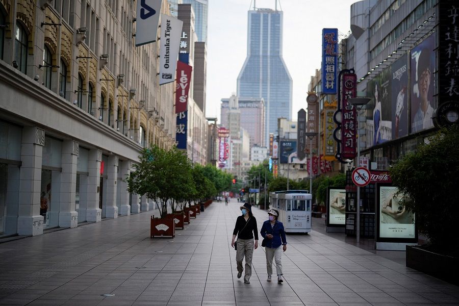 People walk in a main shopping area during lockdown, amid the Covid-19 pandemic, in Shanghai, China, 25 May 2022. (Aly Song/Reuters)