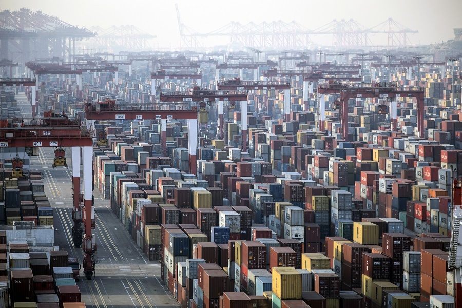Shipping containers next to gantry cranes at the Yangshan Deep Water Port in Shanghai, China, 11 January 2021. (Qilai Shen/Bloomberg)