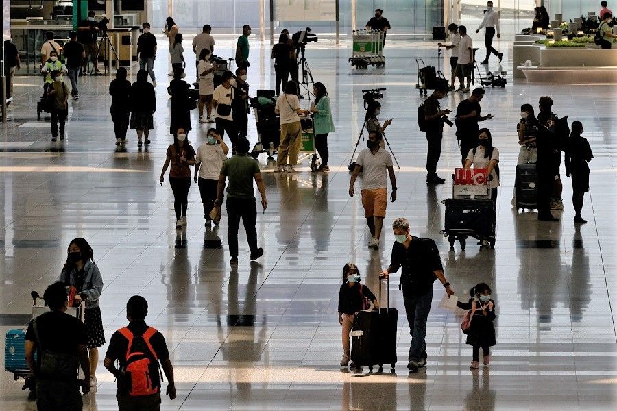 Travellers arrive at the Hong Kong International Airport after the hotel quarantine has been scrapped, in Hong Kong, China, 26 September 2022. (Tyrone Siu/Reuters)