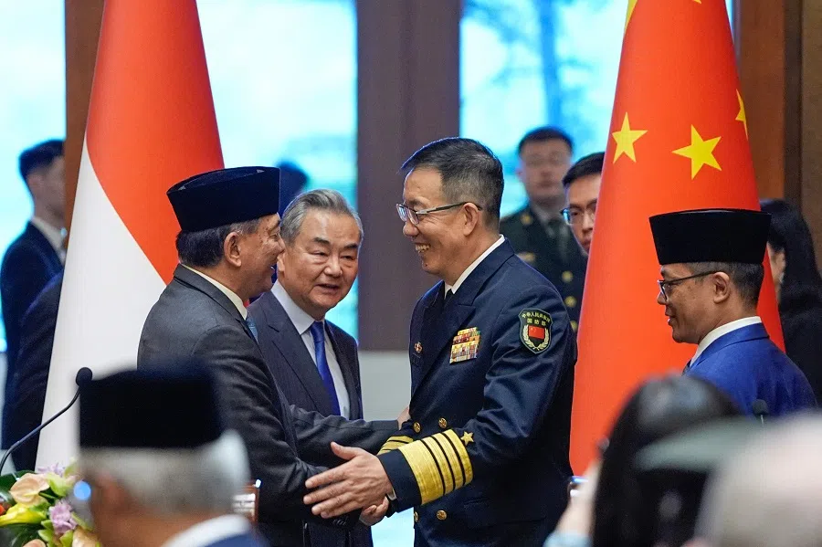 Indonesian Defence Minister Sjafrie Sjamsoeddin (left) shakes hands with Chinese Defence Minister Dong Jun (third from left) as Chinese Foreign Minister Wang Yi (second from left) and Indonesian Foreign Minister Sugiono (right) look on after a press briefing following the first meeting of the China-Indonesia joint foreign and defence ministerial dialogue at the Diaoyutai State Guest House in Beijing on 21 April 2025.  (Iori Sagisawa/Pool/AFP)