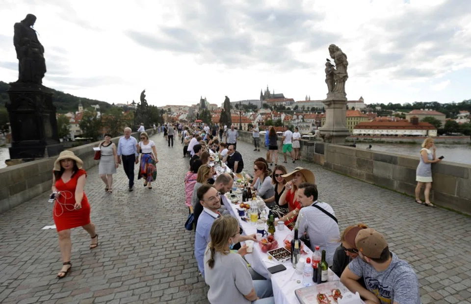 Residents dine at a 500-metre-long table spanning across the length of the medieval Charles Bridge as restrictions ease following the coronavirus disease (COVID-19) outbreak, in Prague, Czech Republic, 30 June 2020. (David W Cerny/REUTERS)