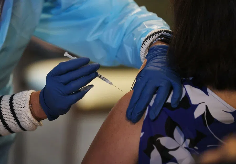 A healthcare worker with American Medical Response, Inc working with the Florida Department of Health in Broward administers a Pfizer-BioNtech Covid-19 vaccine at the John Knox Village Continuing Care Retirement Community on 6 January 2021 in Pompano Beach, Florida. (Joe Raedle/Getty Images/AFP)