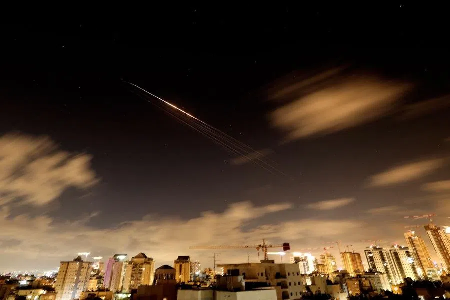 Rocket trails are seen in the sky amid a fresh barrage of Iranian missile attacks above the Israeli coastal city of Netanya on 27 March 2026.