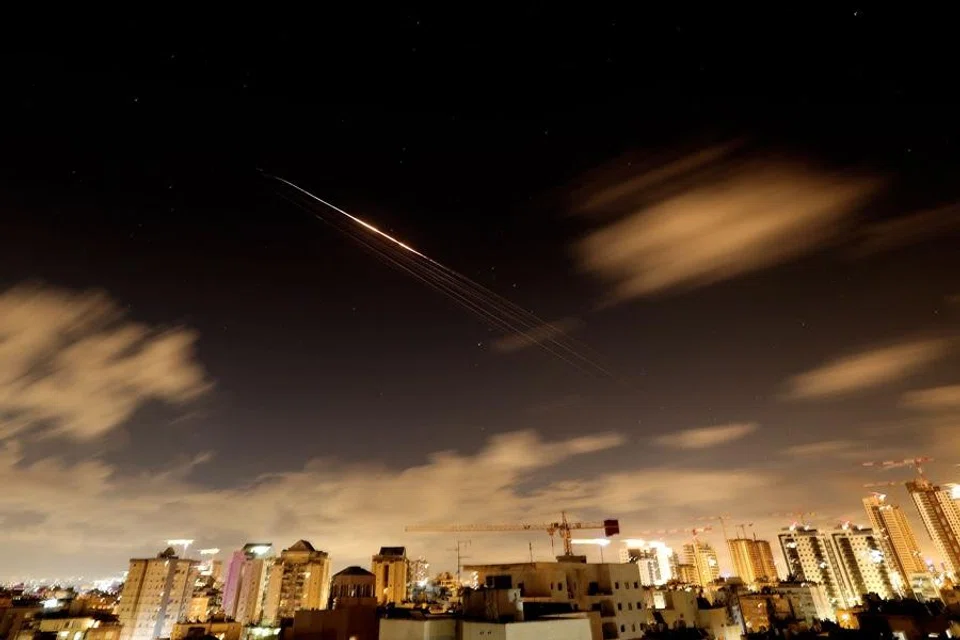 Rocket trails are seen in the sky amid a fresh barrage of Iranian missile attacks above the Israeli coastal city of Netanya on 27 March 2026. (Jack Guez/AFP)