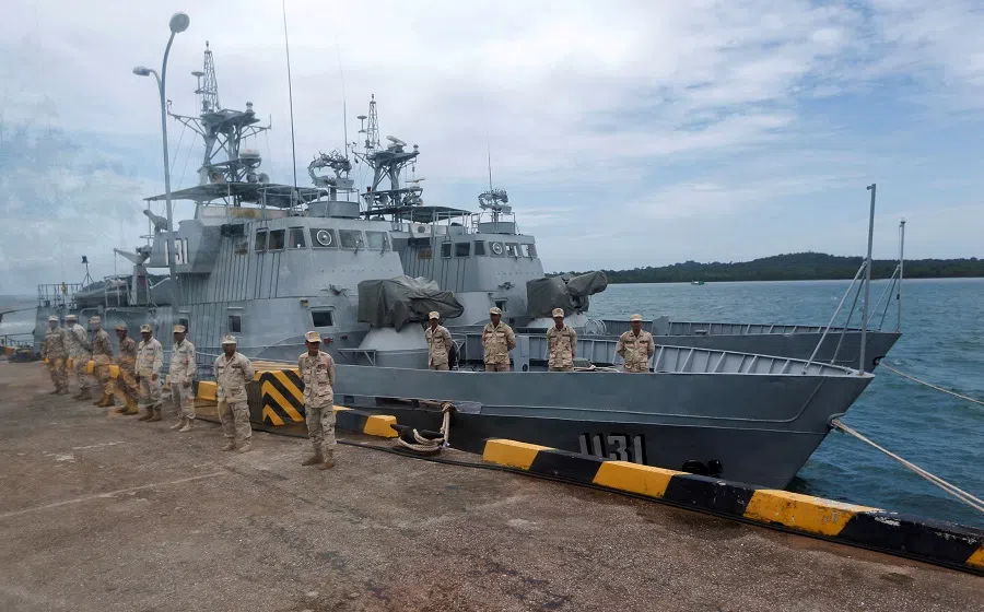 Sailors stand guard near petrol boats at the Cambodian Ream Naval Base in Sihanoukville, Cambodia, on 26 July 2019. (Samrang Pring/Reuters)