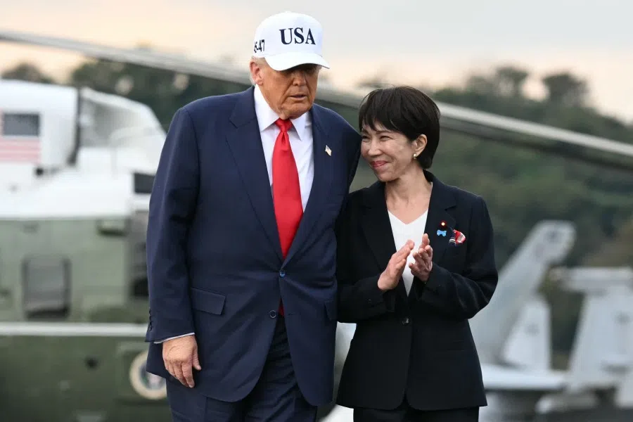 US President Donald Trump (L) and Japan’s Prime Minister Sanae Takaichi arrive on board the US Navy’s USS George Washington aircraft carrier at the US naval base in Yokosuka on 28 October 2025. (Andrew Caballero-Reynolds/AFP)