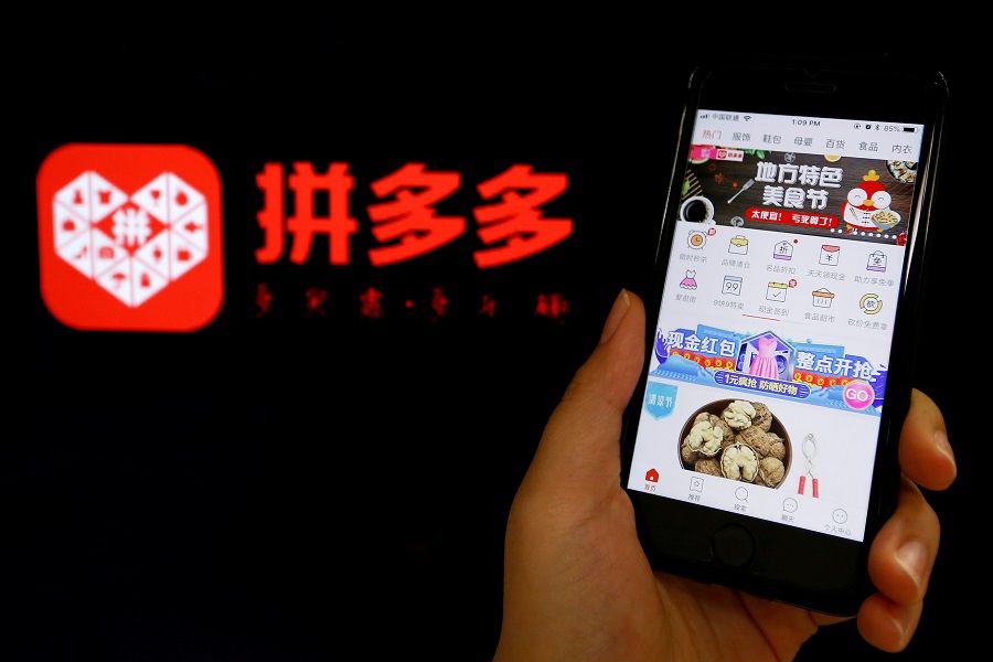 The logo of Chinese online group discounter Pinduoduo is seen next to its mobile phone app in this illustration picture taken 17 July 2018. (Florence Lo/Illustration/File Photo/Reuters)