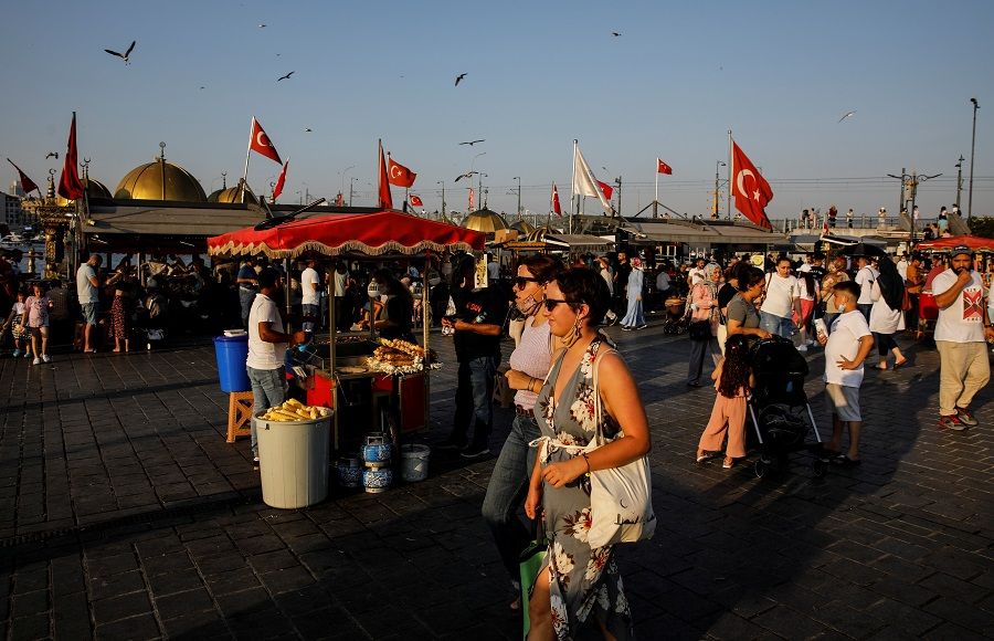 People walk along Eminönü district in Istanbul, Turkey, 12 July 2021. (Umit Bektas/Reuters)