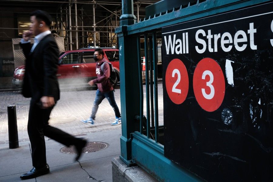 People walk along Wall Street in the financial district of Manhattan on 29 September 2021 in New York City. (Spencer Platt/AFP)
