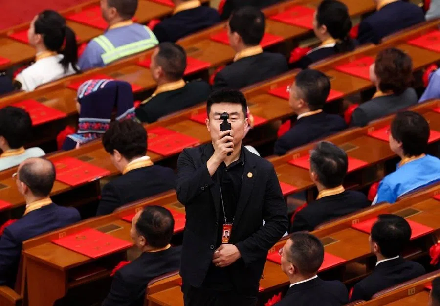 A man films using a mini camera during a ceremony marking the 105th anniversary of the founding of the Communist Party of China at the Great Hall of the People in Beijing, China, on 1 July 2026.